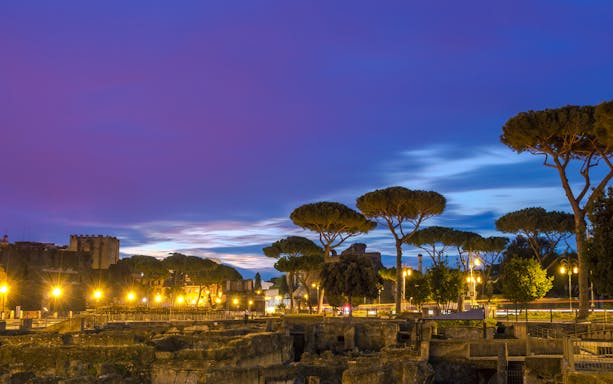 Wide angle view of Roman Forum illuminated at night, Rome.