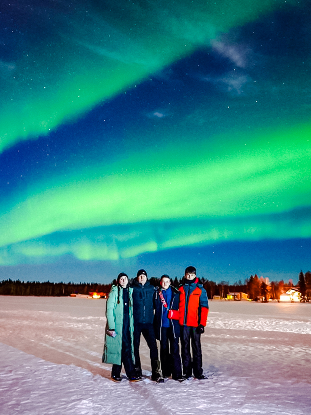 Group watching Northern Lights in Rovaniemi, Finland.