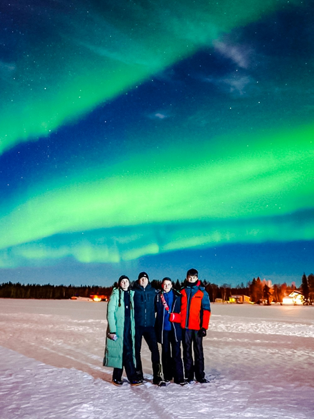 Group watching Northern Lights in Rovaniemi, Finland.