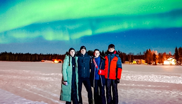 Group watching Northern Lights in Rovaniemi, Finland.