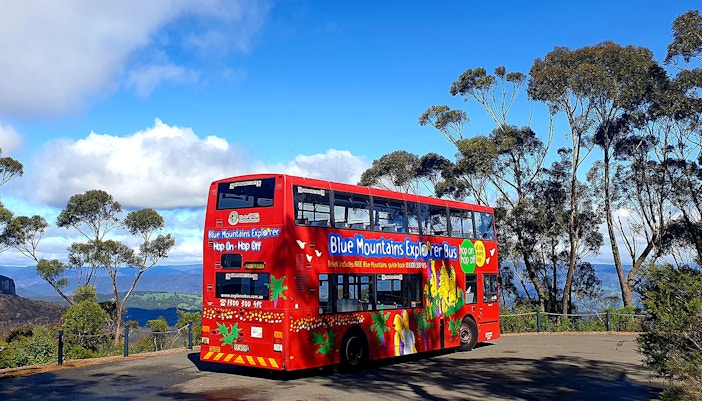 Double-decker bus touring Blue Mountains, showcasing scenic views and lush landscapes in Sydney.