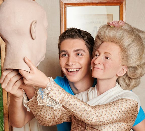 Man posing with wax figure at Madame Tussauds Berlin.