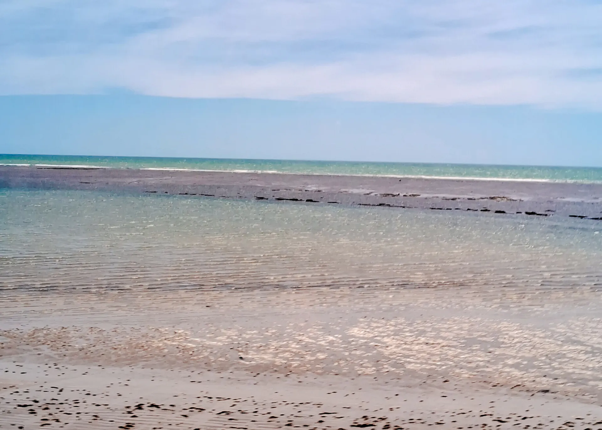 Shallow waters and sandy beach at Coroa Vermelha, Porto Seguro, Brazil.