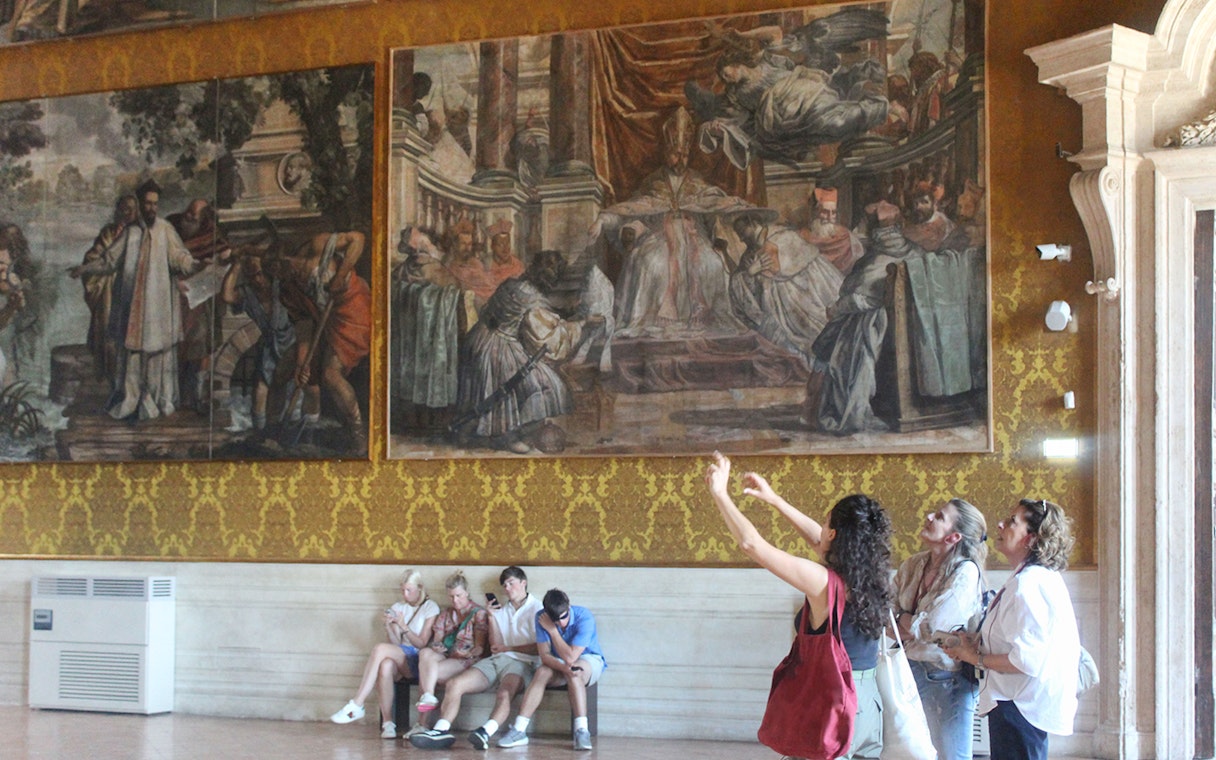 Visitors observing frescoes inside Palazzo Barberini during a guided tour.