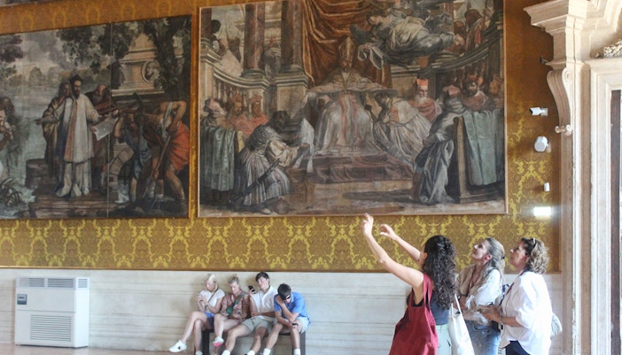 Visitors observing frescoes inside Palazzo Barberini during a guided tour.