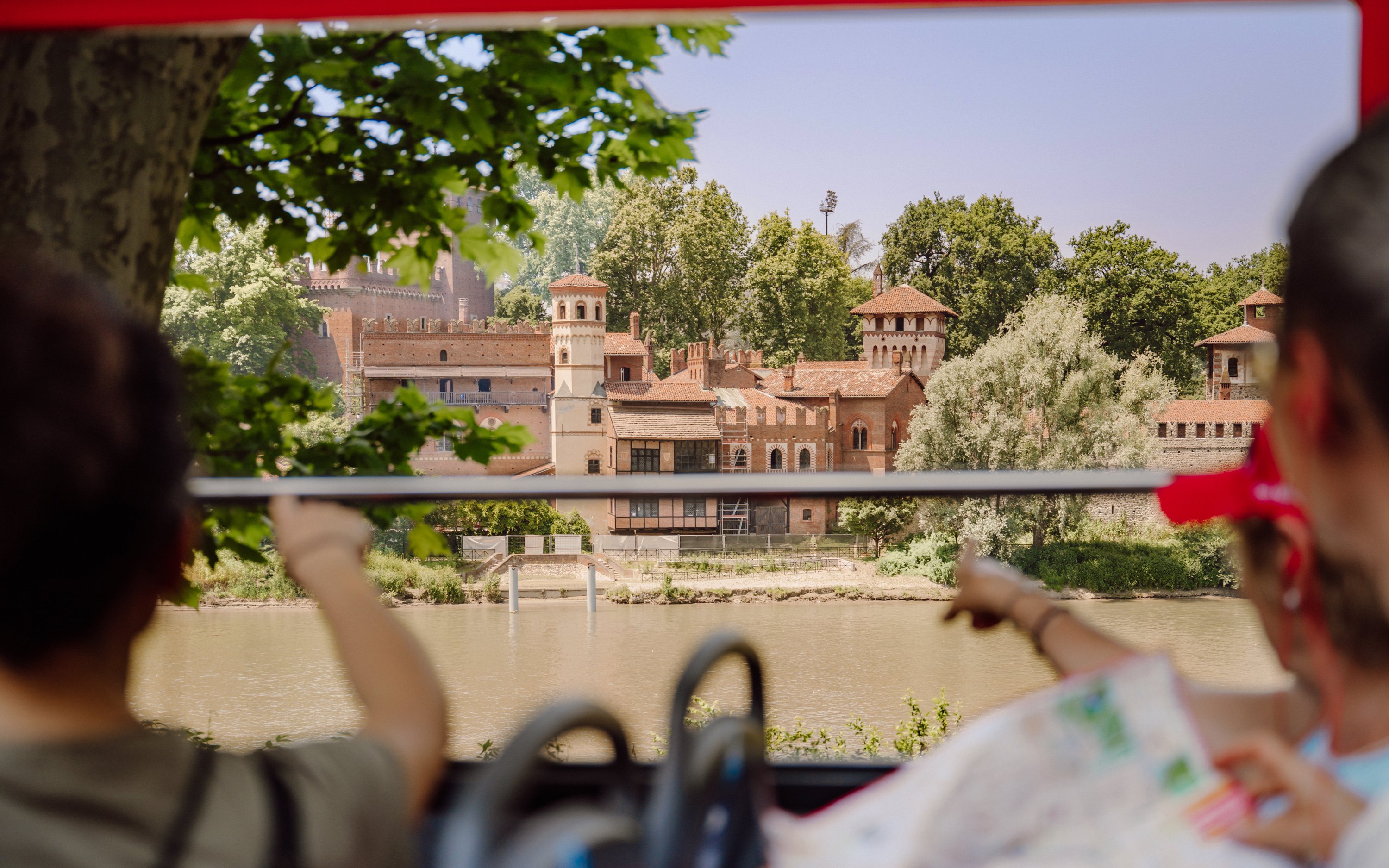 Turin hop-on hop-off bus view of medieval village by the river.