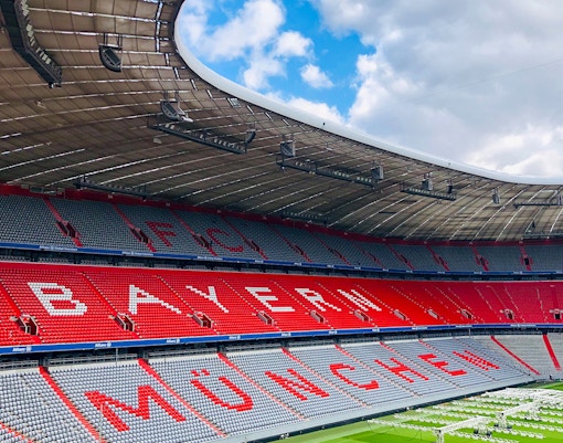Allianz Arena exterior in Munich, Germany, with illuminated facade at night.