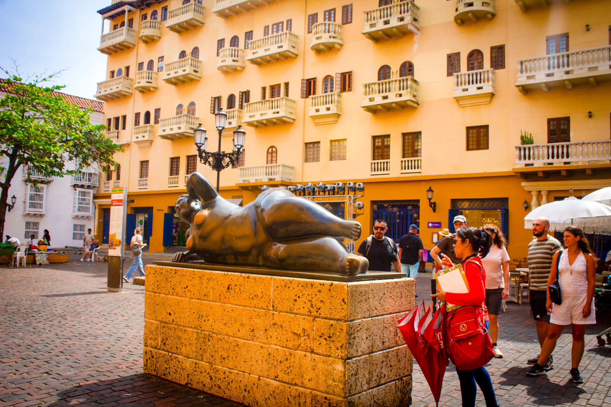 Botero sculpture in Cartagena's Walled Old City with tourists exploring the plaza.