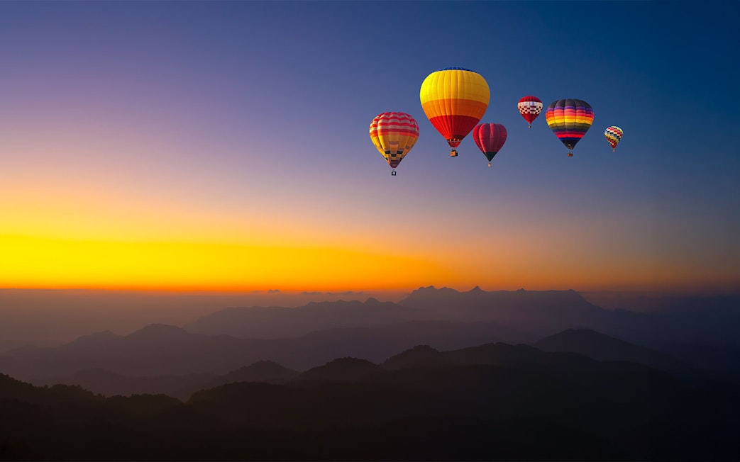 Hot-air balloons over Doi Luang Chiang Dao at sunrise, Chiang Mai.
