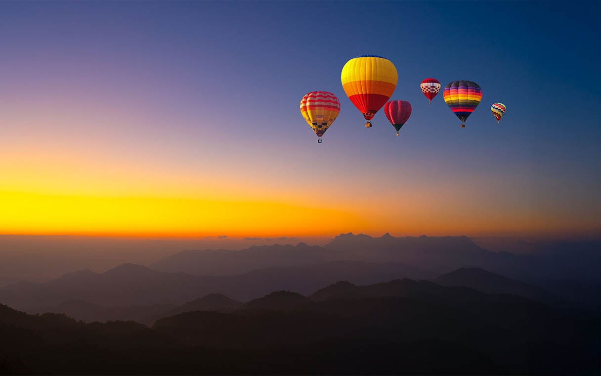 Hot-air balloons over Doi Luang Chiang Dao at sunrise, Chiang Mai.