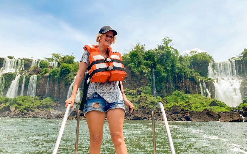 Tourist in life jacket boarding boat at Iguazú Falls, Brazil.