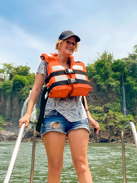 Tourist in life jacket boarding boat at Iguazú Falls, Brazil.