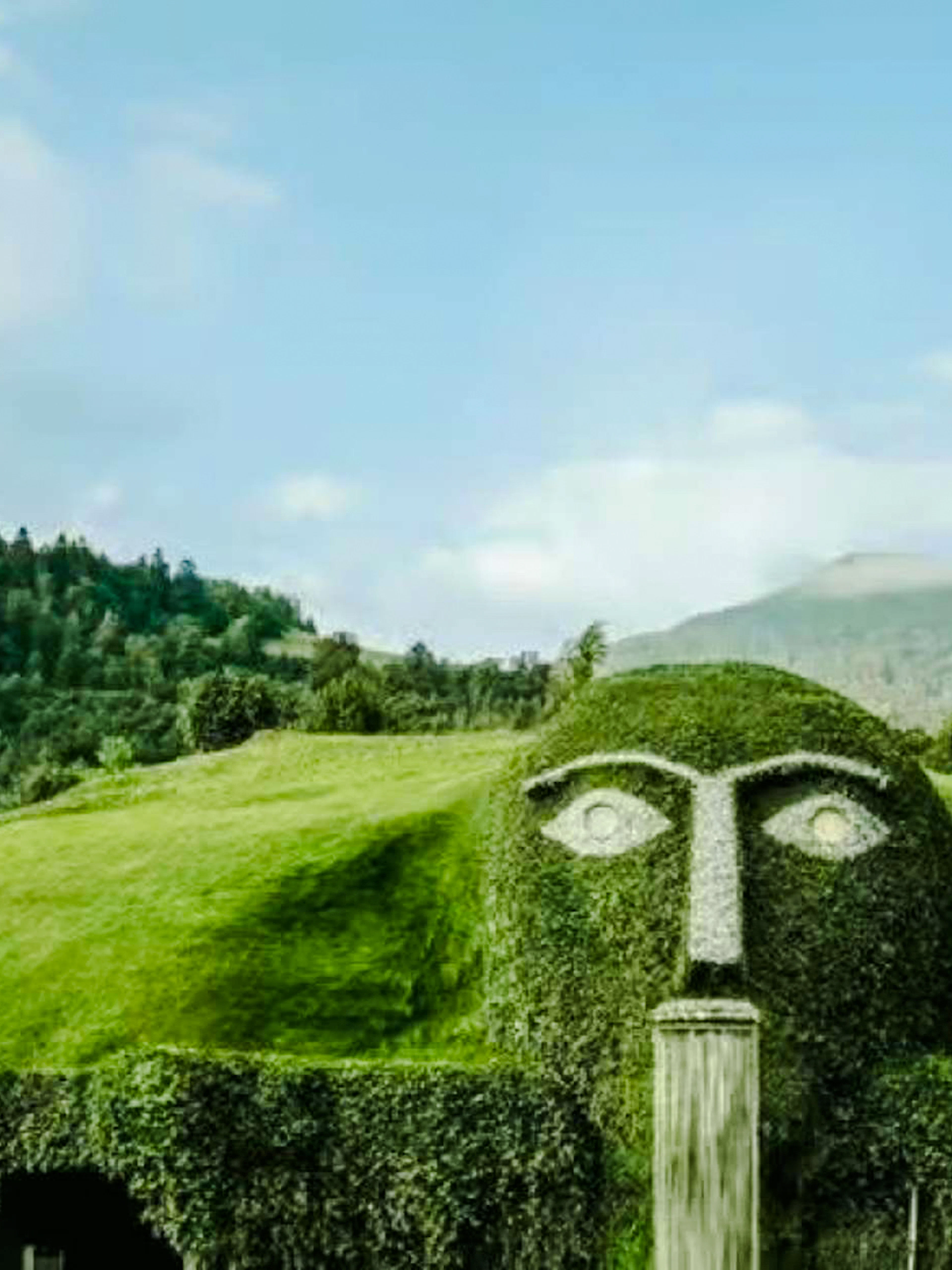 Swarovski Crystal Worlds giant head fountain with mountain backdrop in Innsbruck.