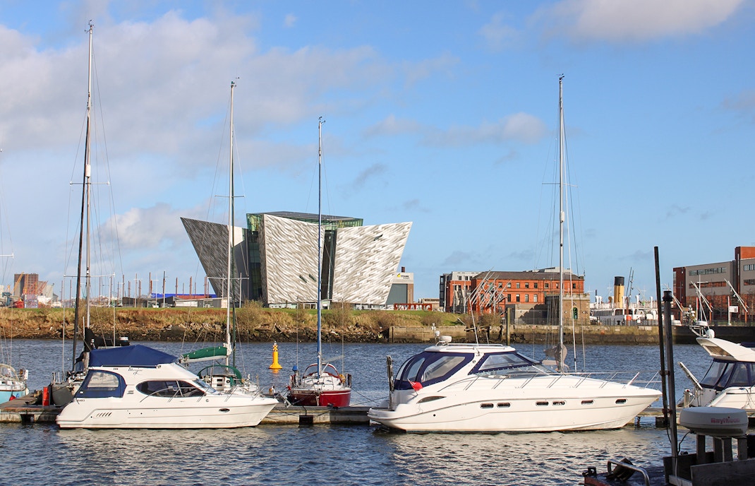 Titanic Belfast Museum exterior with hop-on hop-off bus in United Kingdom.