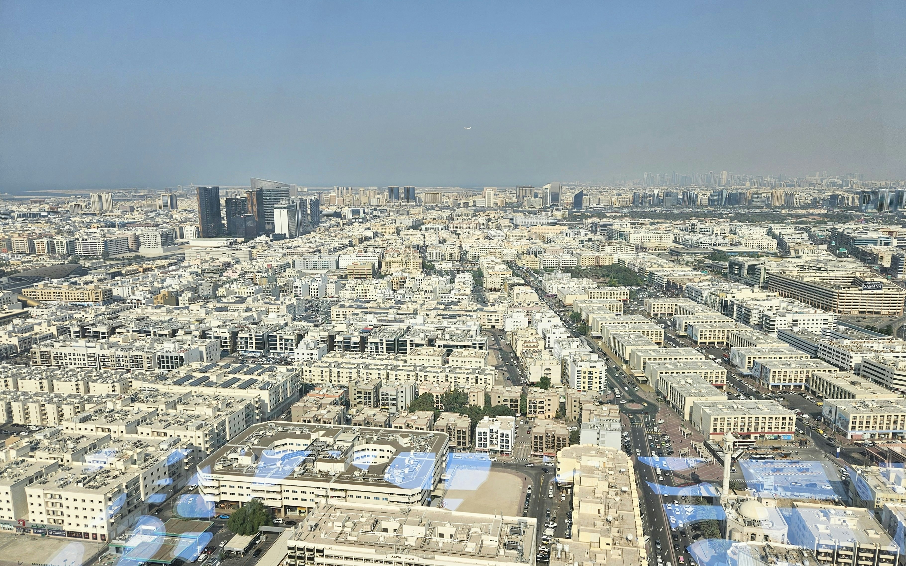 Aerial view of Dubai cityscape from the Dubai Frame, showcasing modern buildings and urban layout.