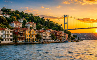 Arnavutköy waterfront with colorful houses and Bosphorus Bridge at sunset, Istanbul.
