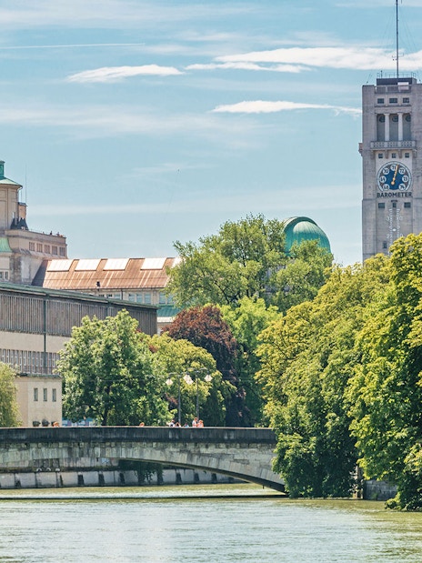 Deutsches Museum in Munich with river and bridge in foreground.