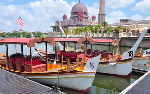 Boats docked at Tasik Putrajaya with Putra Mosque in the background.