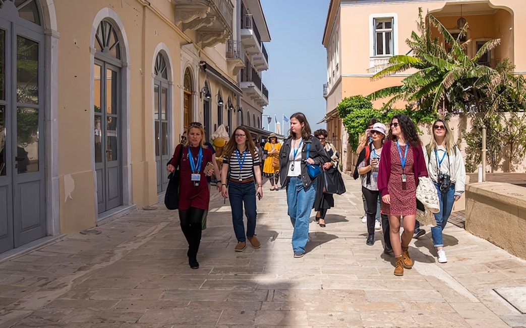 Tour guide leading guests through a street in Nafplion during Ancient Mycenae & Nafplion Premium Tour.