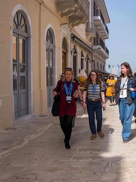 Tour guide leading guests through a street in Nafplion during Ancient Mycenae & Nafplion Premium Tour.