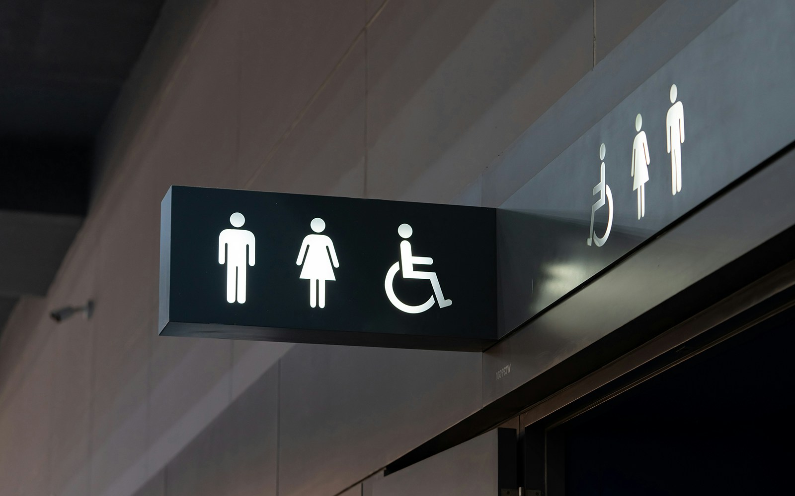 Restroom signs indicating male, female, and accessible facilities.