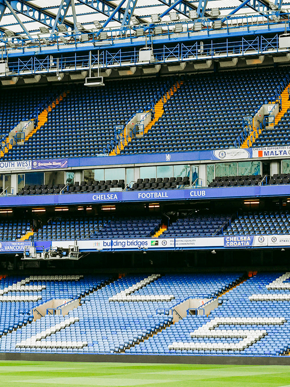 Chelsea FC Stadium seating area with blue and white seats and club signage.