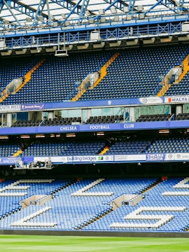 Chelsea FC Stadium seating area with blue and white seats and club signage.