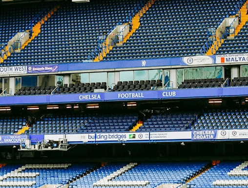 Chelsea FC Stadium seating area with blue and white seats and club signage.