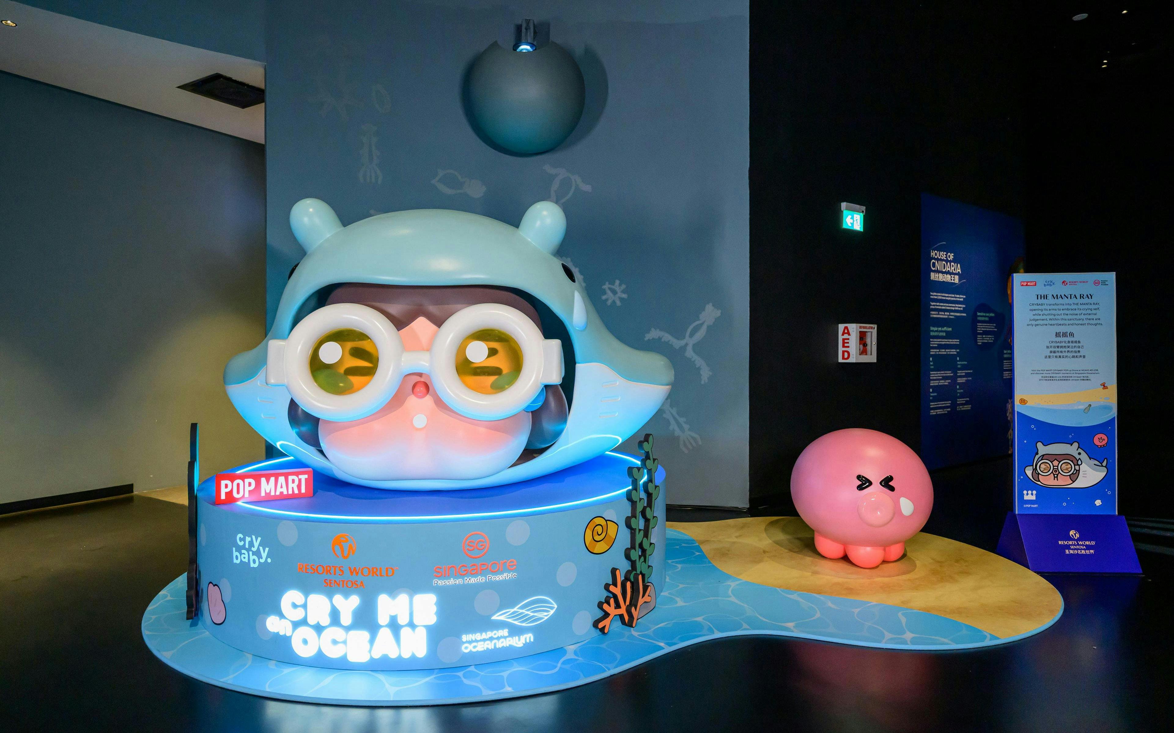 Singapore Oceanarium display featuring a large cartoon character with goggles and a pink octopus figure.