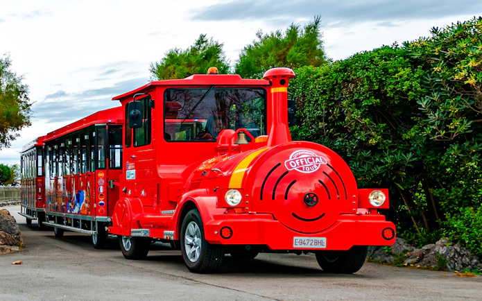 Red tourist train on a scenic route for a panoramic train tour.