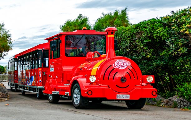 Red tourist train on a scenic route for a panoramic train tour.