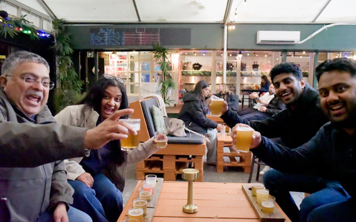 Group enjoying drinks at a cozy bar in Reykjavík during a private bar crawl with a local guide.