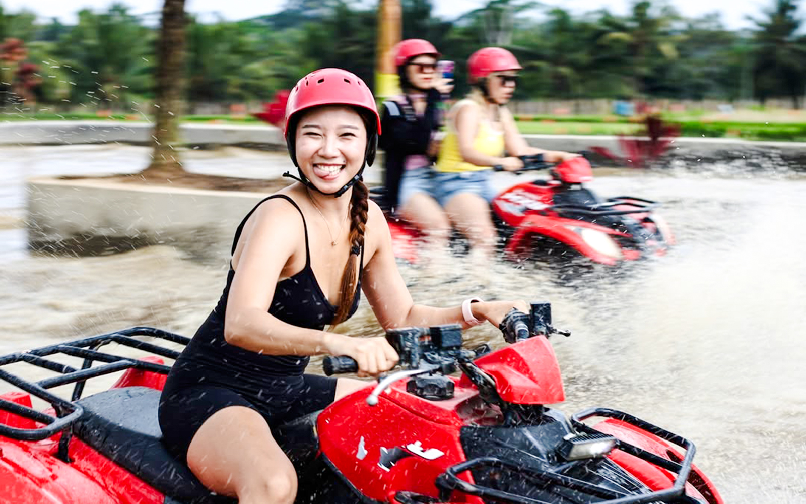 ATV riders splashing through water on Kuber long tunnel tour.