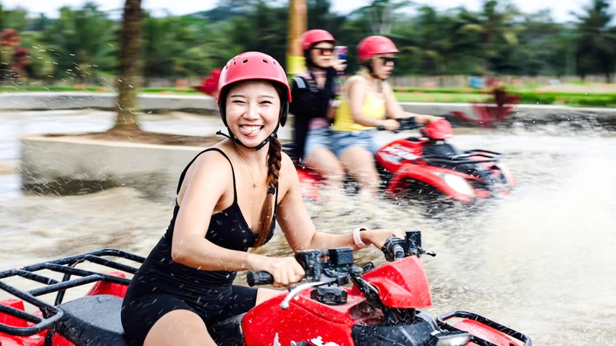 ATV riders splashing through water on Kuber long tunnel tour.