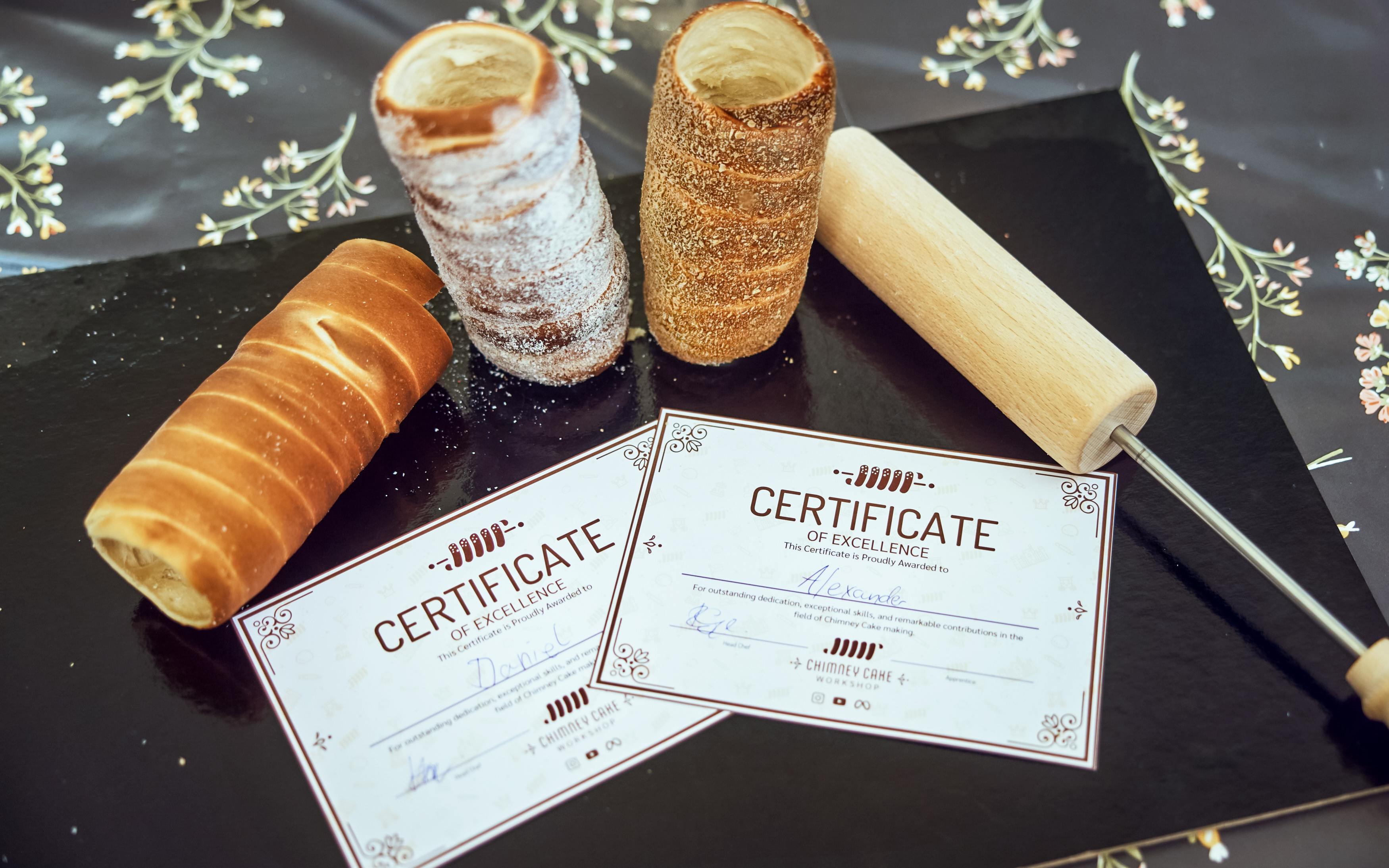 Chimney cakes and certificates at a Budapest Kürtőskalács workshop.