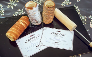 Chimney cakes and certificates at a Budapest Kürtőskalács workshop.