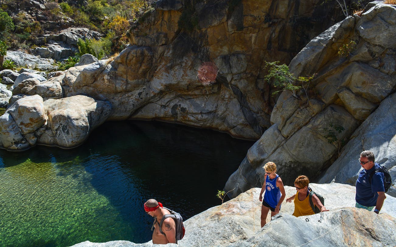 Hikers exploring Fox Canyon trail in Los Cabos, Mexico during a guided hiking tour.