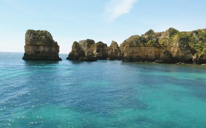 Ponta da Piedade cliffs and turquoise waters on a private cruise in Lagos, Portugal.