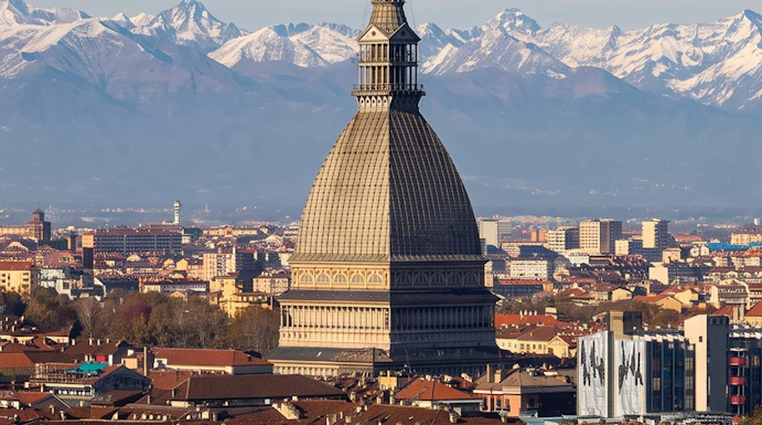 Mole Antonelliana with Alps backdrop, Turin, home to National Cinema Museum.