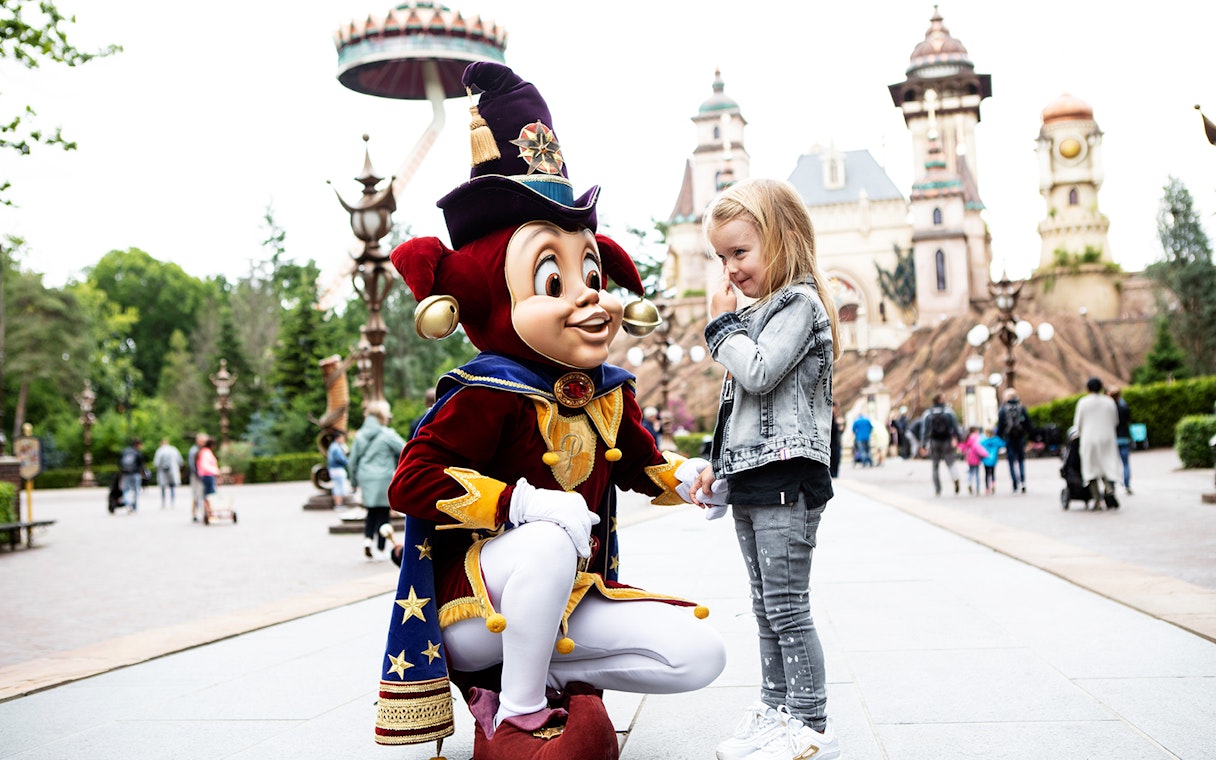 Child meeting a character at Efteling theme park, Netherlands.