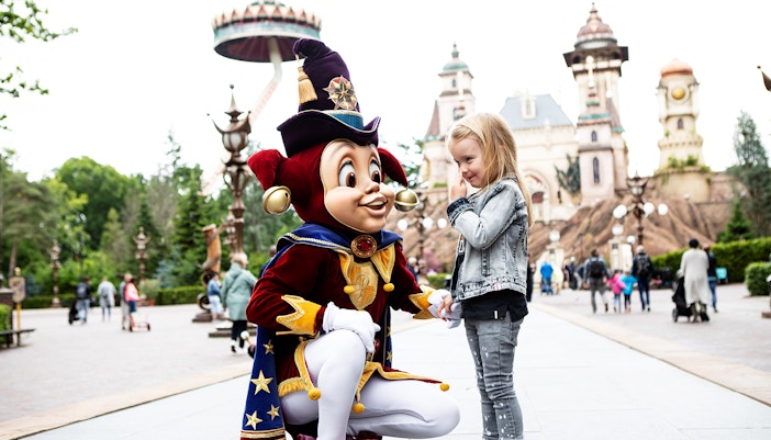 Child meeting a character at Efteling theme park, Netherlands.