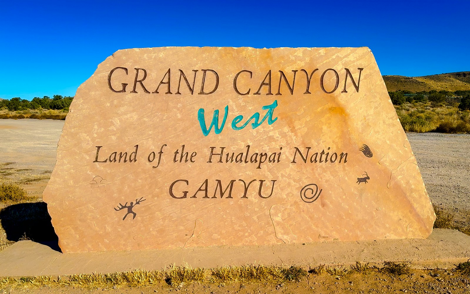 Grand Canyon West sign at Hualapai Nation entrance, highlighting cultural significance and tour starting point.