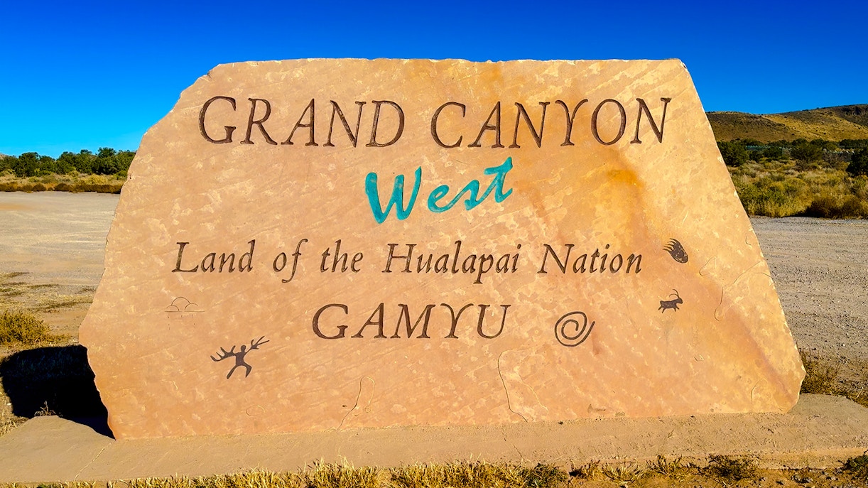 Grand Canyon West sign at Hualapai Nation entrance, highlighting cultural significance and tour starting point.