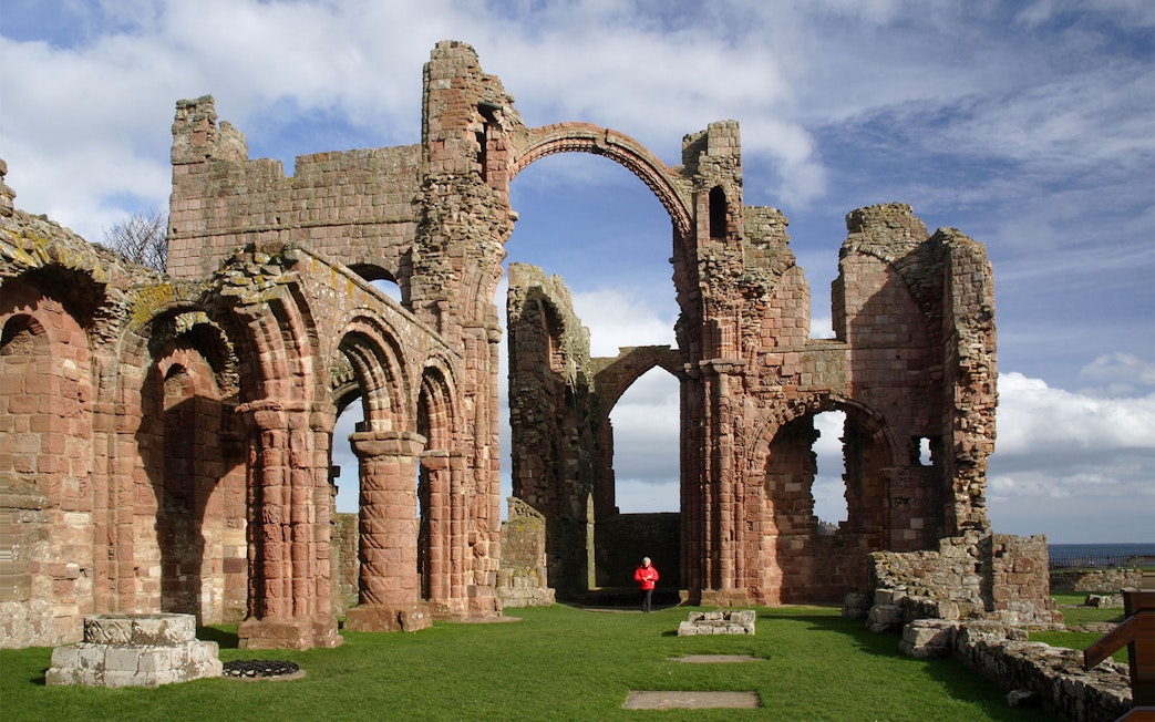 Lindisfarne Priory ruins with arches on Holy Island, England.