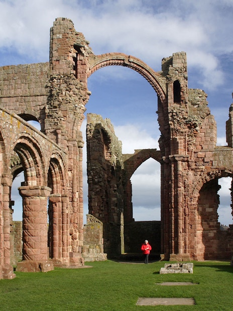 Lindisfarne Priory ruins with arches on Holy Island, England.