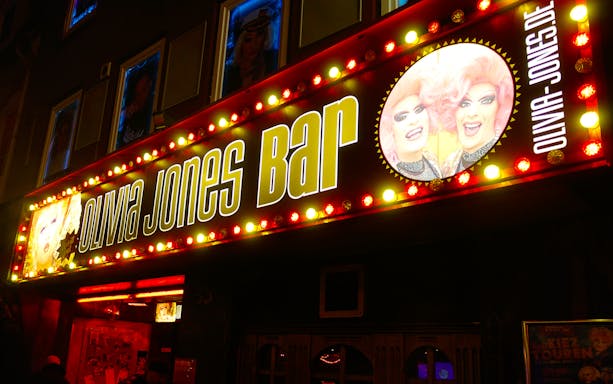 Olivia Jones Bar entrance in Hamburg's Kiez district, featuring bright signage.