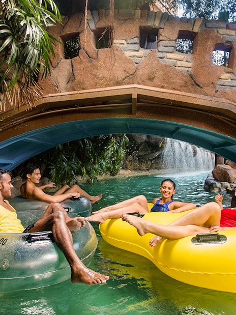 Visitors enjoying a lazy river ride at Sunway Lagoon's water park, Zambezi River attraction.