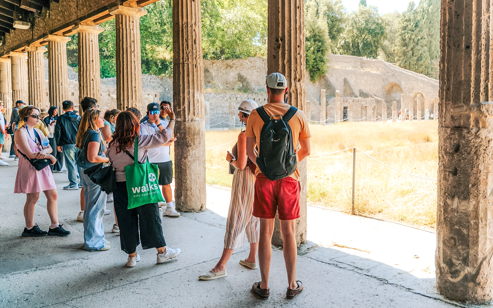 Ancient ruins of Pompeii with Mount Vesuvius in the background, showcasing historical architecture.