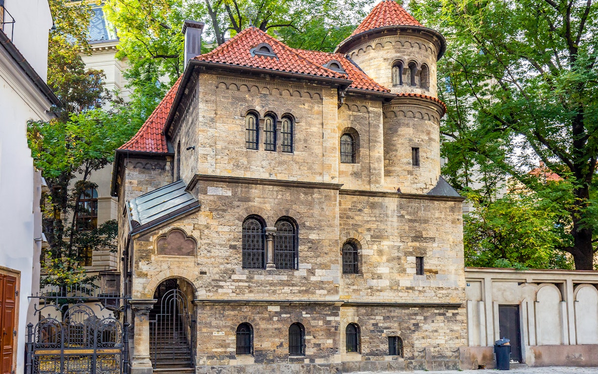 Historic building in Prague's Jewish Quarter with red-tiled roof and arched windows.