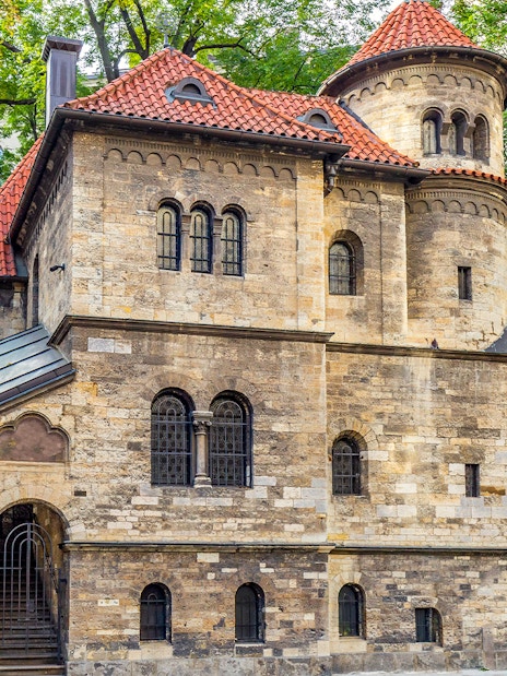 Historic building in Prague's Jewish Quarter with red-tiled roof and arched windows.